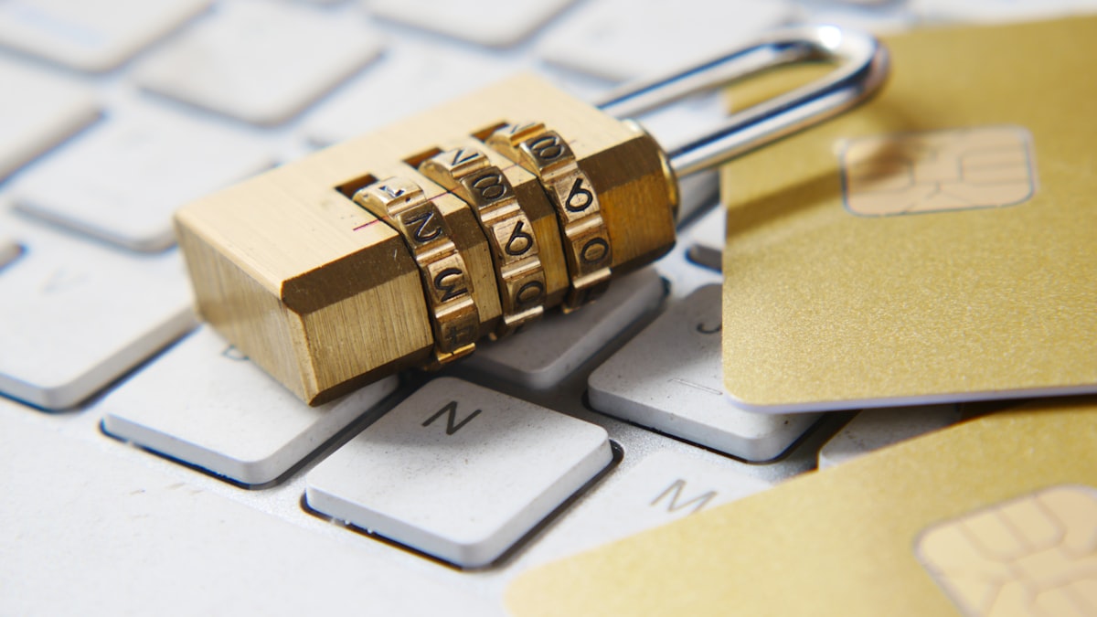 A golden padlock resting on a laptop keyboard, representing website data security